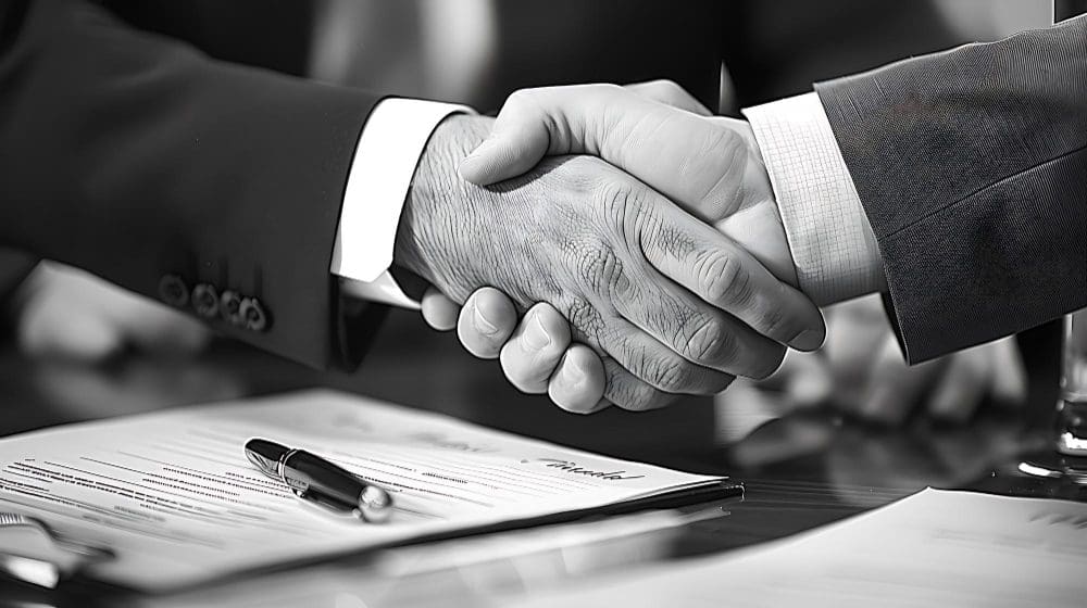 Handshakes across a desk following U.S. business formation.