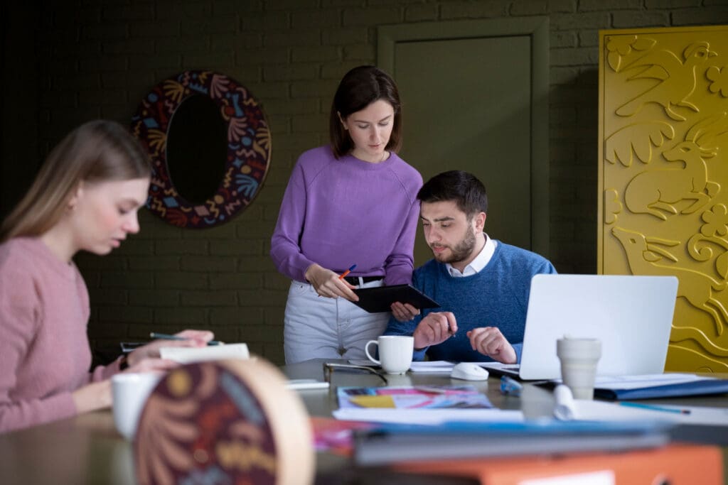 Medium shot of startups collaborating in an office